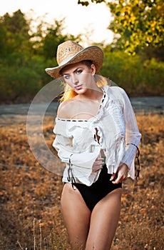 Fashion portrait woman with hat and white shirt in the autumn day