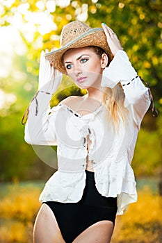 Fashion portrait woman with hat and white shirt in the autumn day