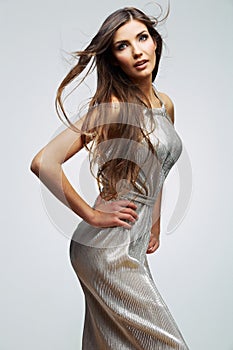 Fashion portrait of woman with long hair in silver dress .