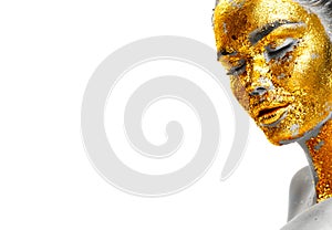 Fashion portrait of woman`s golden face closeup. Model girl with cracked gold foil on skin. Jewellery