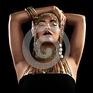 Fashion, portrait and woman in studio with gold, beauty and royal, jewellery or attitude on black background. Face