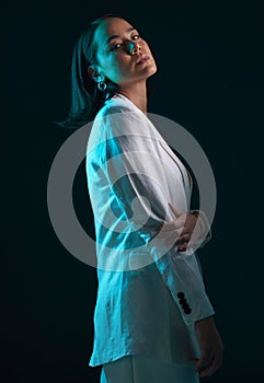 Fashion, portrait and a woman in a suit on a dark background for a corporate aesthetic. Serious, stylish and an Asian