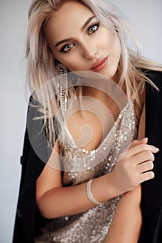 Fashion portrait of a young beautiful blonde woman indoor in studio