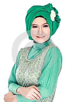 Fashion portrait of young beautiful muslim woman with green cost