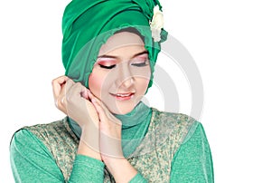 Fashion portrait of young beautiful muslim woman with green cost