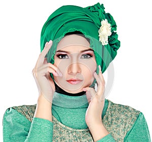 Fashion portrait of young beautiful muslim woman with green cost