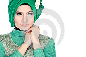 Fashion portrait of young beautiful muslim woman with green cost