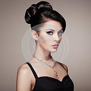 Fashion portrait of young beautiful woman with elegant hairstyle