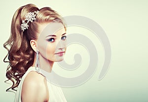 Fashion portrait of young beautiful woman with elegant hairstyle