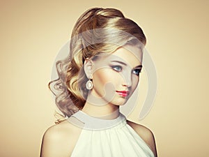 Fashion portrait of young beautiful woman with elegant hairstyle