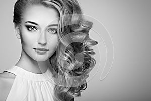 Fashion portrait of young beautiful woman with elegant hairstyle