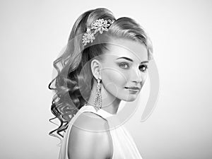 Fashion portrait of young beautiful woman with elegant hairstyle