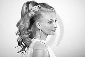 Fashion portrait of young beautiful woman with elegant hairstyle