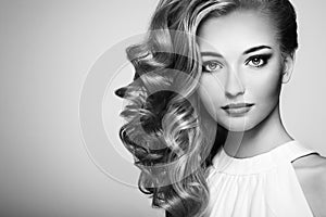 Fashion portrait of young beautiful woman with elegant hairstyle