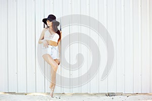 Fashion portrait of young beautiful woman in hat and sunglasses