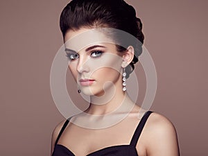 Fashion portrait of young beautiful woman with jewelry