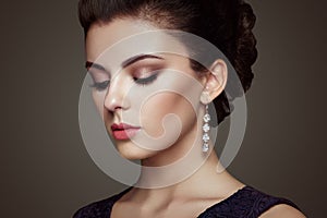 Fashion portrait of young beautiful woman with jewelry photo