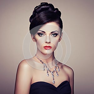 Fashion portrait of young beautiful woman with jewelry