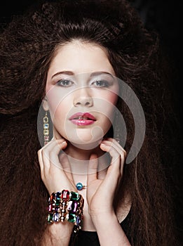Fashion portrait of young beautiful woman with jewelry and elegant hairstyle.Perfect make-up. Beauty style model.