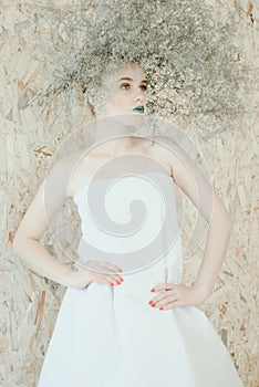 Fashion portrait of Young blond woman in white dress .Beautiful woman with green lips. Concept of Mother Nature