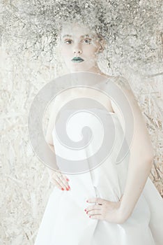 Fashion portrait of Young blond woman in white dress .Beautiful woman with green lips. Concept of Mother Nature