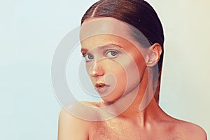 Fashion portrait of young elegant girl. Paslet background, studio shot. Beautiful brunette woman with gold lips and golden bright