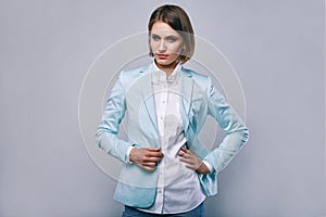 Fashion portrait of young elegant woman in azure man jacket