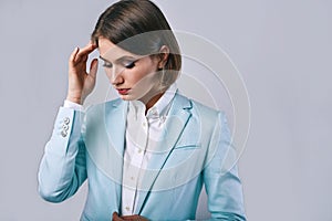 Fashion portrait of young elegant woman in azure man jacket