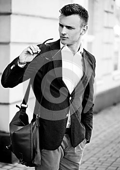 Fashion portrait of a young handsome casual man looking away