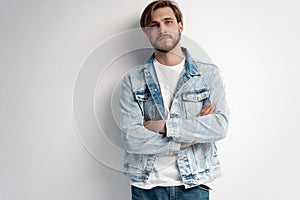 Fashion portrait of young man wearing jeans jacket.