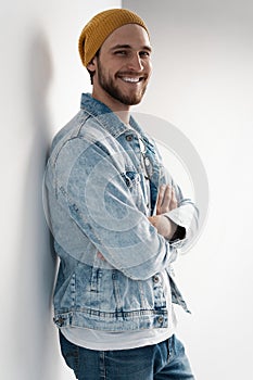 Fashion portrait of young man wearing jeans jacket.