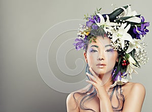 Fashion Portrait of Young Woman with Beautiful Flowers