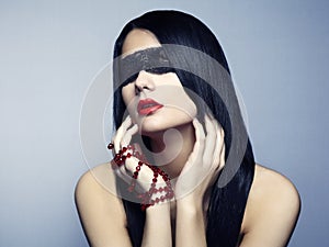 Fashion portrait of the young woman blindfold