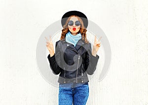 Fashion portrait young woman making air kiss red lips