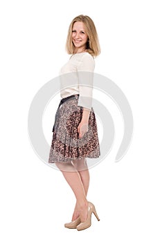 Fashion portrait young woman in skirt posing full length isolated over white