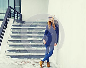 Fashion pretty blonde woman wearing jacket and hat in winter