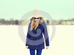 Fashion pretty blonde woman wearing jacket hat in winter day