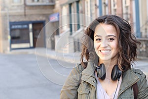 Fashion pretty cool girl wearing headphones having fun over urban background