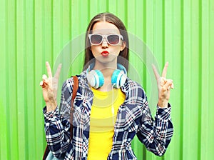 Fashion pretty cool girl wearing a sunglasses and headphones