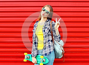 Fashion pretty cool girl wearing a sunglasses, skateboard