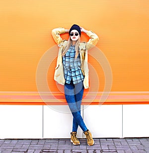 Fashion pretty woman model posing over orange background