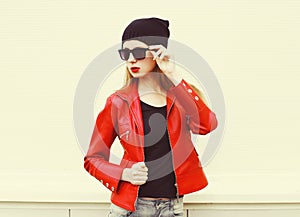 Fashion pretty woman wearing a rock red leather jacket, sunglasses and black hat