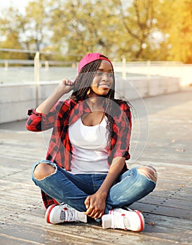 Fashion pretty young african woman having fun in city park