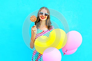 Fashion pretty young smiling woman with yellow an air balloons