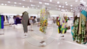 Fashion, retail and shop, blurred interior view of apparel clothing store in luxury shopping mall as defocused