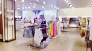 Fashion, retail and shop, blurred interior view of apparel clothing store in luxury shopping mall as defocused