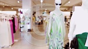 Fashion, retail and shop, blurred interior view of apparel clothing store in luxury shopping mall as defocused