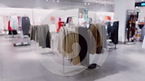 Fashion, retail and shop, blurred interior view of apparel clothing store in luxury shopping mall as defocused