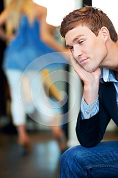 Fashion, retail and store with a tired man waiting for a woman while shopping in a clothing boutique. Patient person