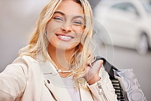 Fashion, shopping bag and portrait of woman in city with smile, retail therapy and financial freedom. Budget, walking